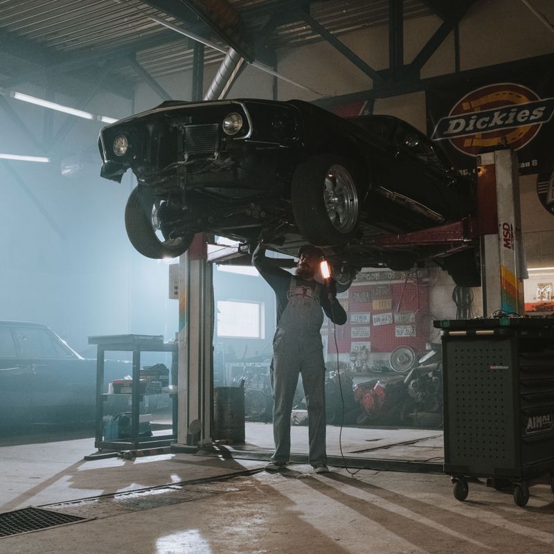 Mechanic inspecting a vehicle on a lift